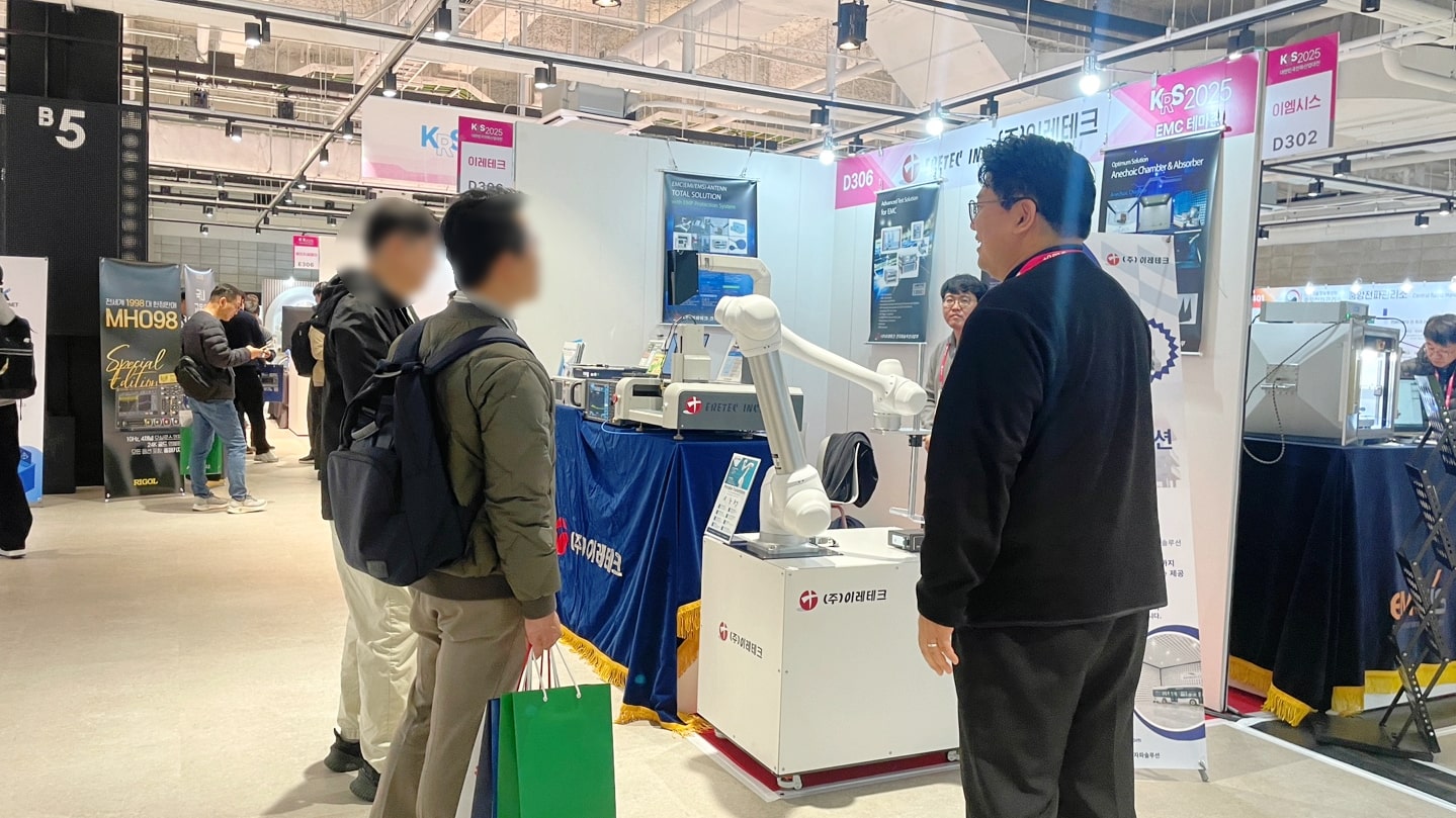 Staff explaining to visitors at the 2025 Korea korea radiocommunication show Exhibition booth.